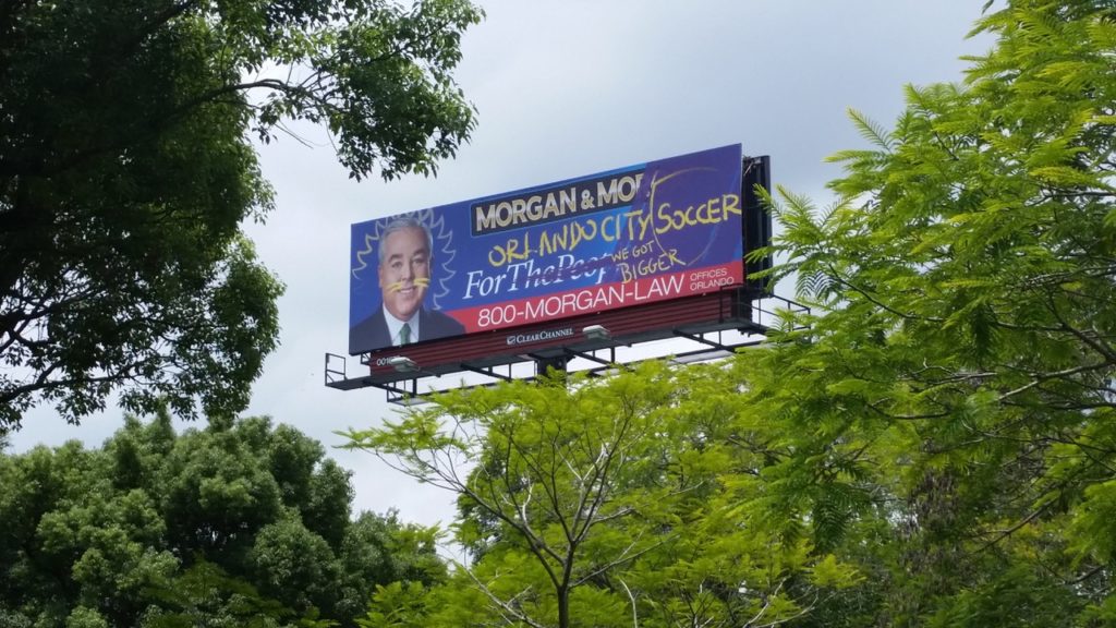 A Morgan & Morgan billboard vandalized to promote the Orlando City Lions